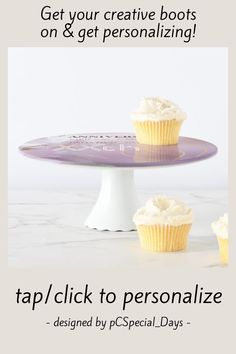 two cupcakes sitting on top of a cake plate with the words tap click to personalize