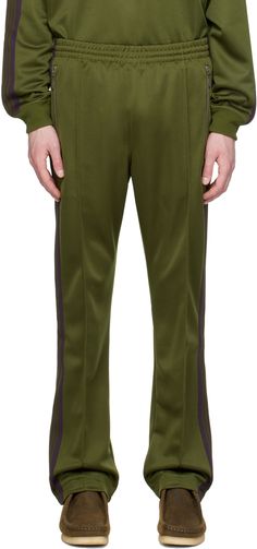 Polyester interlock jersey track pants. · Concealed drawstring at elasticized waistband · Three-pocket styling · Logo graphic embroidered at front · Pinched seam at legs · Striped knit trim at outseams Supplier color: Olive Mens Khakis, Mens Activewear, Sports Logo, Striped Knit, Logo Graphic, Track Pants, Apparel Accessories, Active Wear, Track