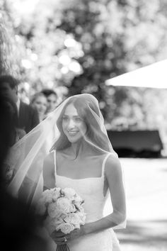 the bride smiles as she walks down the aisle