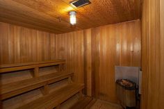 an empty sauna with wooden walls and floor