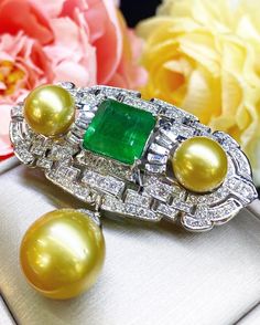 SPECTACULAR! ONE OF A KIND, ART DECO, HANDCRAFTED 18K WHITE GOLD PENDANT/BROOCH, FEATURING AN ENORMOUS 11.32 CARATS ZAMBIAN, CLASSIC EMERALD-CUT EMERALD AND TOP GRADE, SPARKLING, NATURAL, UNTREATED DIAMONDS! WITH HUGE 15 mm GOLDEN SOUTH SEA PEARL & 2 pieces of 12 mm Golden South Sea Pearls! Set in 18K solid white gold brooch! EMERALD: Weight: 11.32 carats! Vivid sweet green, with great transparency. SI1 clarity emerald. Few internal imperfections, visible but not noticeable when worn. Natura Exquisite Gold Platinum Jewelry, White Gold Pendant With 17 Jewels, Formal Green Jewelry With High Luster, Formal Green High Luster Jewelry, Exquisite Platinum Jewelry With Polished Finish, Elegant Green Platinum Jewelry, Luxury Formal Pendant Jewelry, Luxury Polished Emerald Jewelry, Luxury White Gold Emerald Jewelry