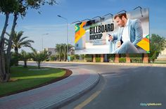 an advertisement for billboards is shown on the side of a road in front of palm trees