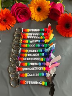 a bunch of colorful crayons sitting on top of a table next to flowers