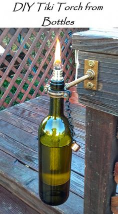 a brown bottle with a candle in it hanging from a chain on a wooden bench