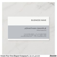 a white and gray business card on a marble surface