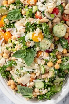 a salad with broccoli, chickpeas, cucumbers and cheese