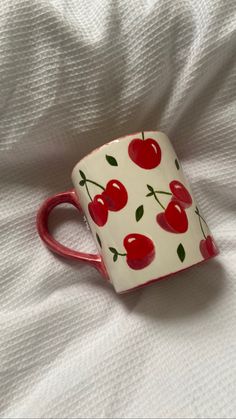 painted cherry mug on duvet Aesthetic Cup Painting, Cherry Pottery Mug, Cherries Pottery Painting, Cup Designs Painting, Cherry Mug Painting, Painting On Cups Ideas, Pottery Painting Fruit Design, Cherry Ceramic Mug, Diy Cup Painting