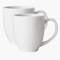 two white coffee mugs sitting next to each other on a white surface with no background