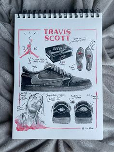 a drawing of travis scott's shoes and other items on a bed with gray sheets