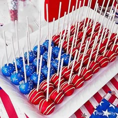 red, white and blue cake pops are on display