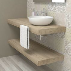 a bathroom sink sitting on top of a wooden shelf next to a wall mounted mirror