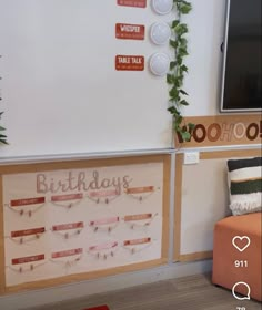 there is a birthday sign on the wall next to a couch and television set in front of it