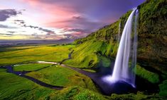 a large waterfall with a bible verse on it's side in front of a sunset