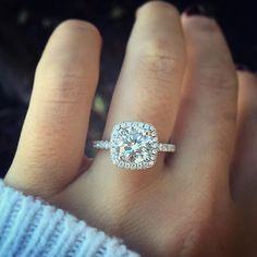 a woman's hand with a diamond ring on it