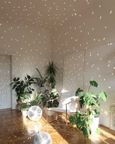 a room with some plants in it and stars on the wall above them that are falling from the ceiling