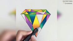 someone is drawing a colorful diamond with colored pencils on the white paper and it looks like they are holding something in their hand