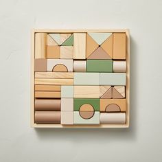 a wooden block with geometric shapes on it