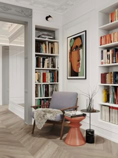 a living room with bookshelves and a chair in the middle of the room