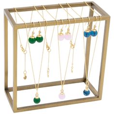 a display case with several different necklaces and earrings hanging from it's sides