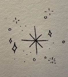 an ink drawing of a star in the middle of it's design on paper