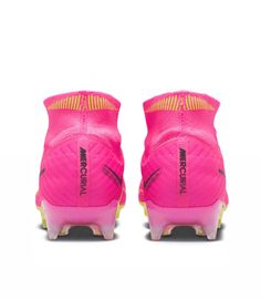 a pair of pink and yellow soccer cleats