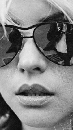 black and white photograph of a woman wearing sunglasses