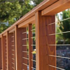 a close up of a wooden fence with metal bars on the top and bottom part