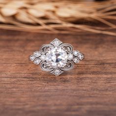 a diamond ring sitting on top of a wooden table