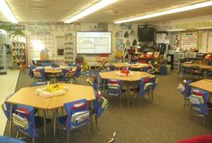 a classroom filled with lots of tables and chairs