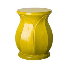 a yellow vase sitting on top of a white table