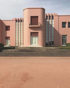 a large pink building with steps leading up to it