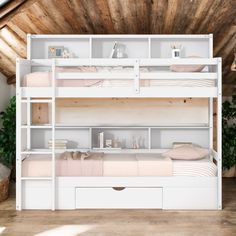 a white bunk bed sitting next to a wooden floor in a room with wood walls