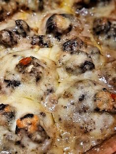 a close up view of a pizza with cheese and meat toppings on the crust