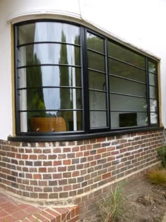 an image of a brick house with large windows