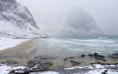 the beach is covered in snow and rocks