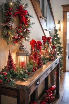 christmas decorations and lights on a mantle in a house with stairs leading up to the front door