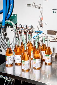 several bottles of wine are lined up on a table in front of a medical machine