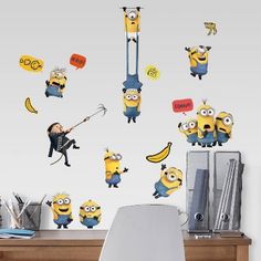 the minions wall decals are hanging on the wall next to a desk and chair