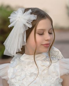 Make a statement with this one-of-a-kind Butterfly Tulle Hair Bow! Lightweight and oh-so-pretty, this bow dangles sweetly from your hair and features a butterfly and faux pearl detail to make you irresistible. Flutter into the spotlight in this must-have accessory! Lightweight White Tulle Hair Bow with delicate Butterfly and Faux Pearl detail in the center. Comfortable hair clasp in the back. Suitable for 1 Year and Up. Measures approximately 6" x 8.5". 100% Tulle Polyester. Handmade in Turkey. View entire Butterfly Ceremony Collection. Care Instructions: Do not wash. Spot clean only. Do not rub. Tulle Hair Bow, Tulle Hair Bows, Hair Clasp, Delicate Butterfly, White Tulle, A Butterfly, Signature Design, Hair Bow