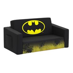 a black and yellow batman couch with the bat symbol on it