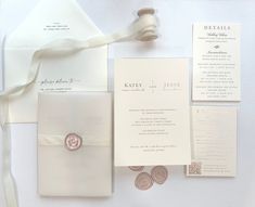 the wedding stationery is laid out on top of each other