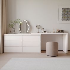 a white dresser and mirror in a room