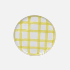 a yellow and white checkered plate on a white background