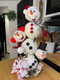 a group of snowmen sitting on top of a wooden table