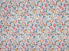 an image of a flowery fabric with blue and pink flowers on the back ground