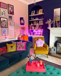 a living room filled with colorful furniture and pictures on the wall above it's fireplace