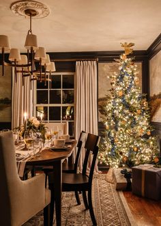 a dining room with a christmas tree in the corner