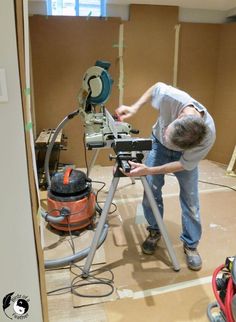 a man using a circular saw to cut wood