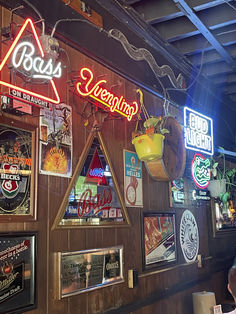 a restaurant with many neon signs on the wall