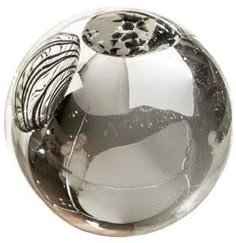 a glass ball with a silver and black design on it